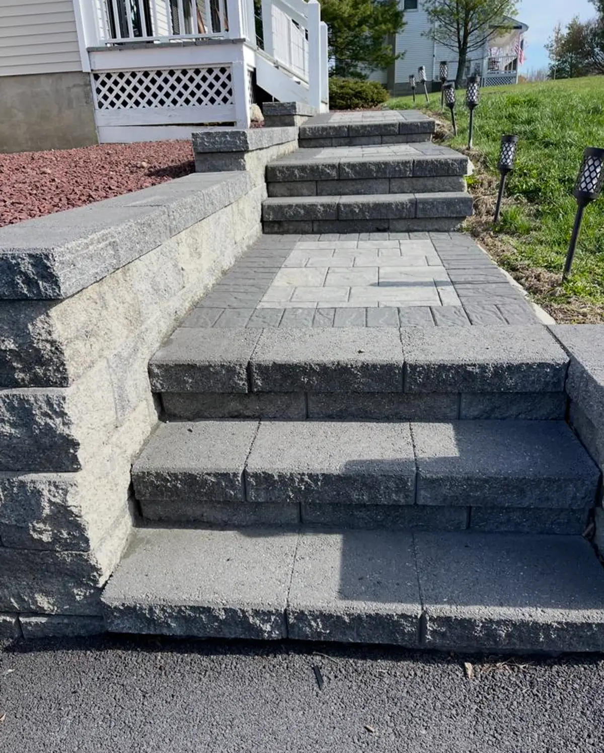 Stone stairs and retaining wall built into a residential entry