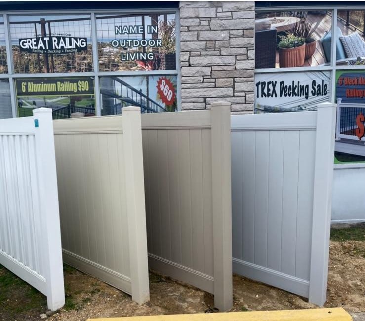 Vinyl privacy fence panels in white, tan, and gray